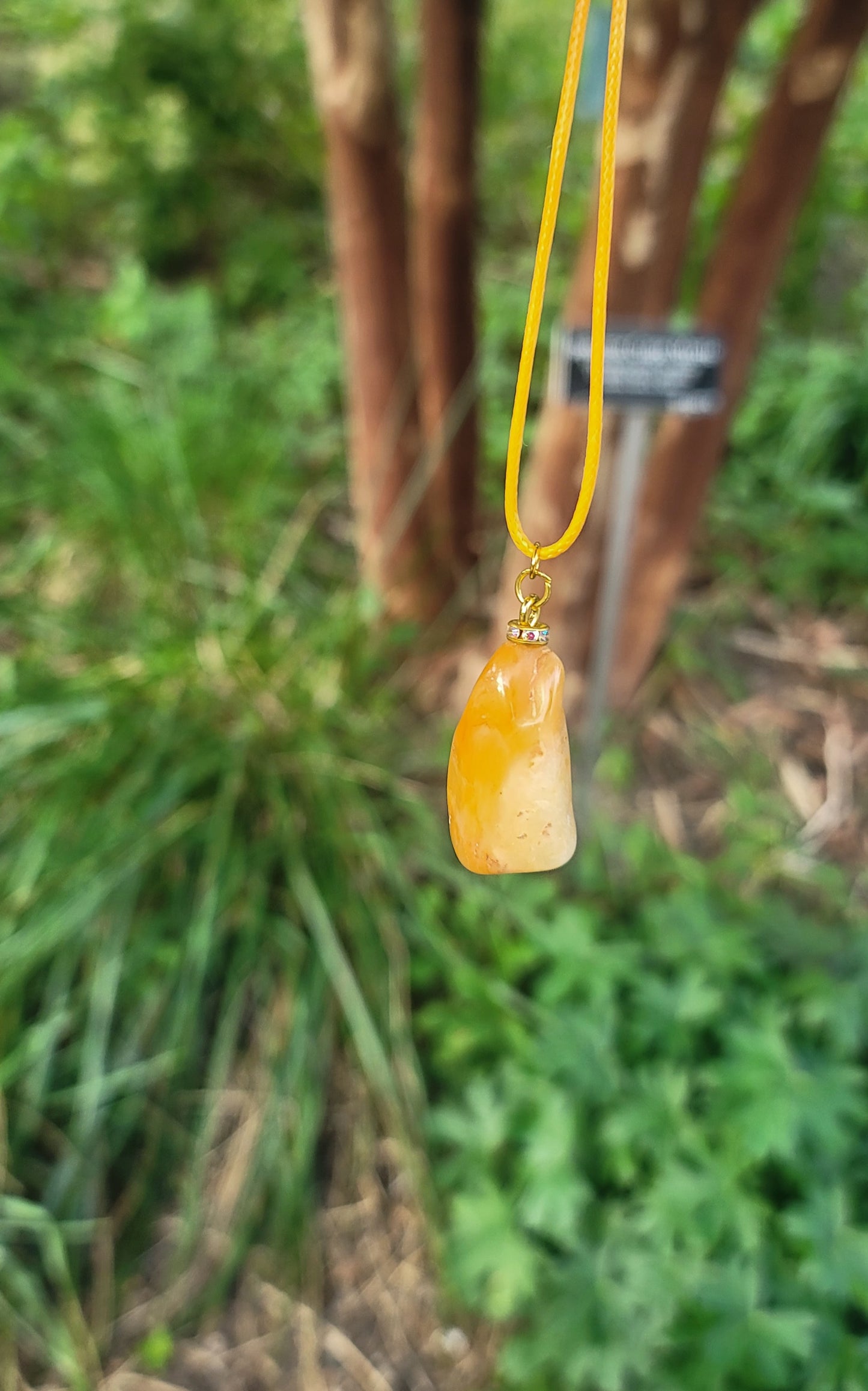 THIS YELLOW AVENTURINE GEMSTONE PENDANT IS SURE TO DELIGHT THE WEARER.