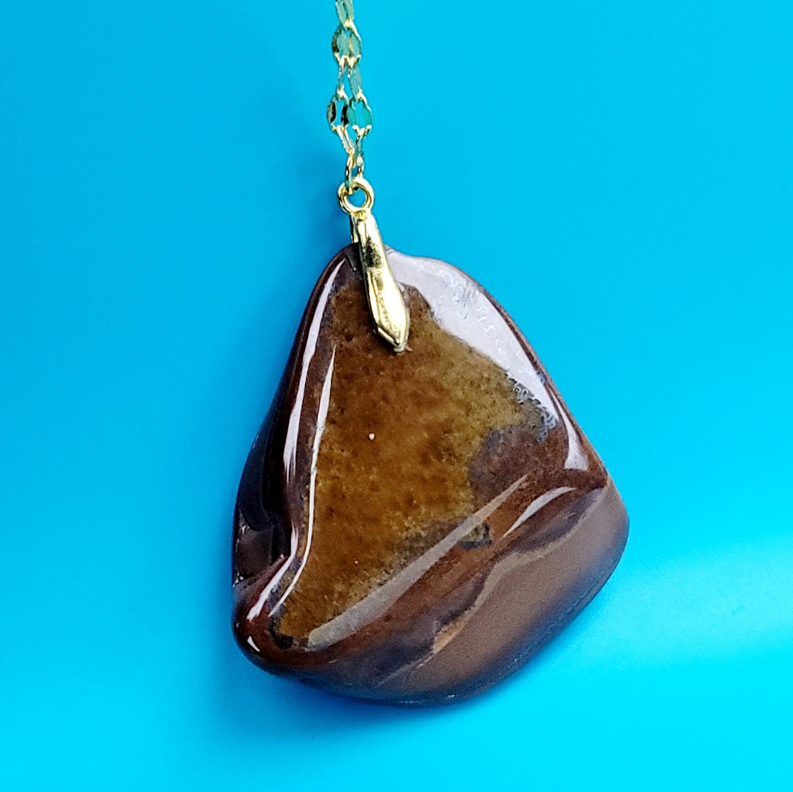 This bold desert jasper pendant is expertly crafted from stunning, natural jasper stone. Its unique, bold design exudes confidence and style, making it the perfect statement piece for any outfit