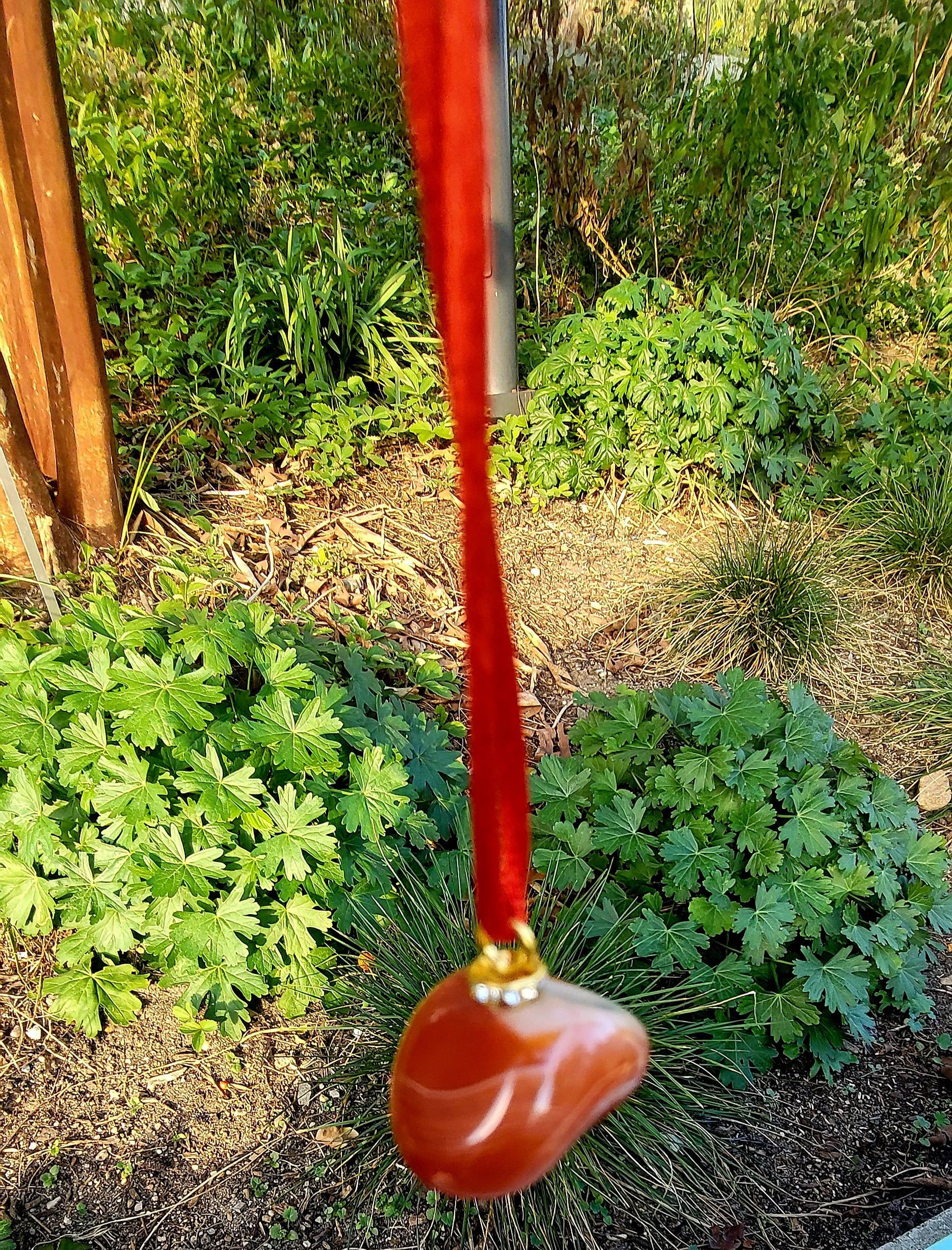 This is an intriguing and Beautiful Carnelian Agate Pendant. It is trimmed with a 20" Polyester string.