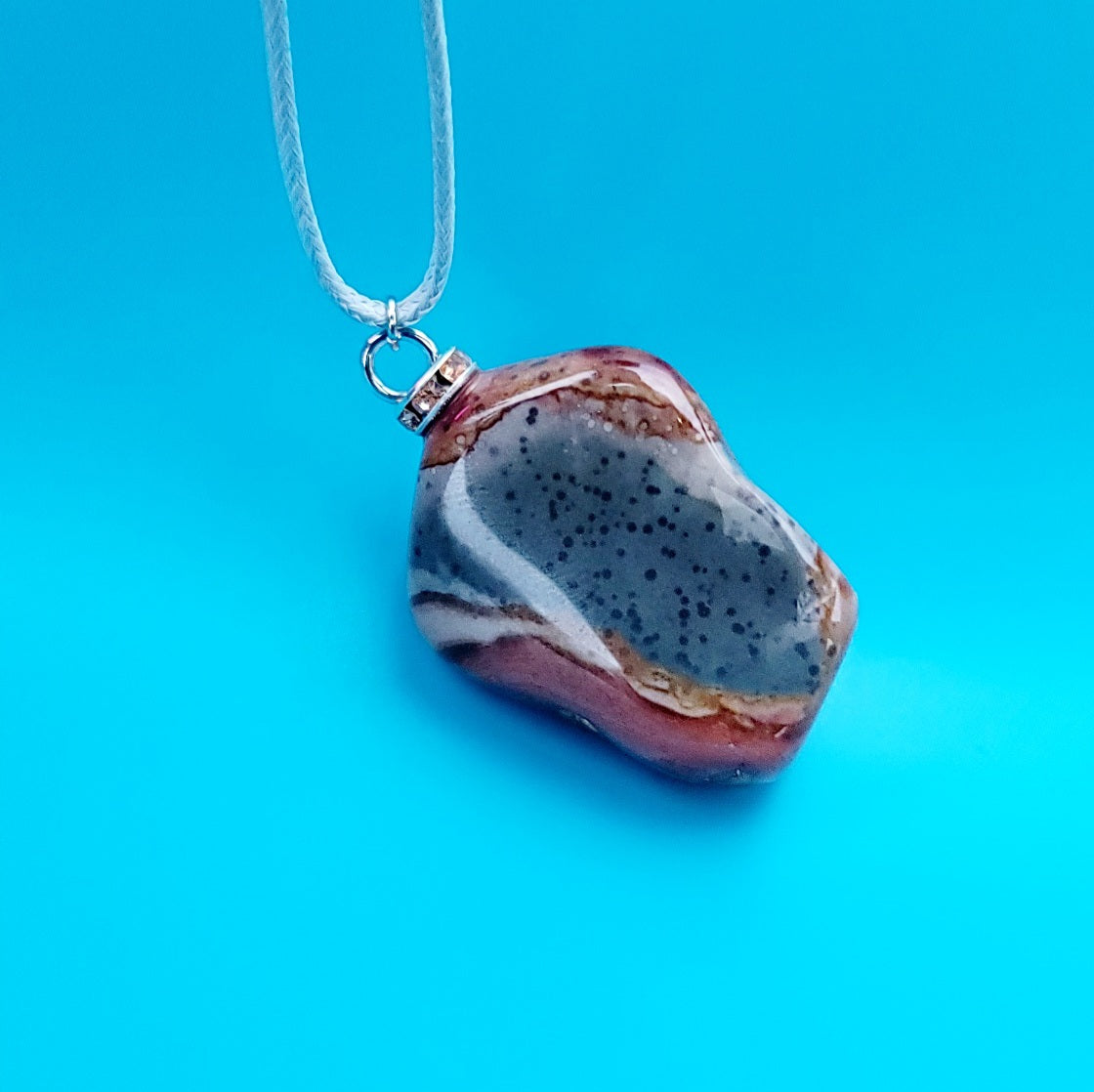 AMAZING DESERT JASPER PENDANT with extremely intricate color patterns and details! This is a very intricate and mesmerizing piece, featuring amazing color patterns and design. The shape is also super unique and will definitely stand out in the crowd!