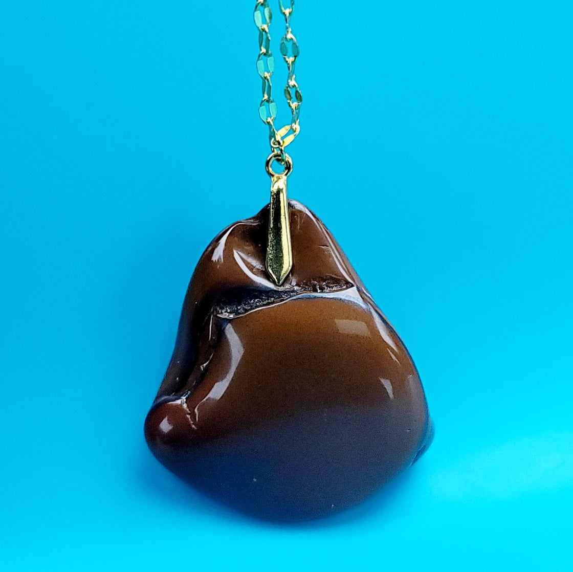 This bold desert jasper pendant is expertly crafted from stunning, natural jasper stone. Its unique, bold design exudes confidence and style, making it the perfect statement piece for any outfit